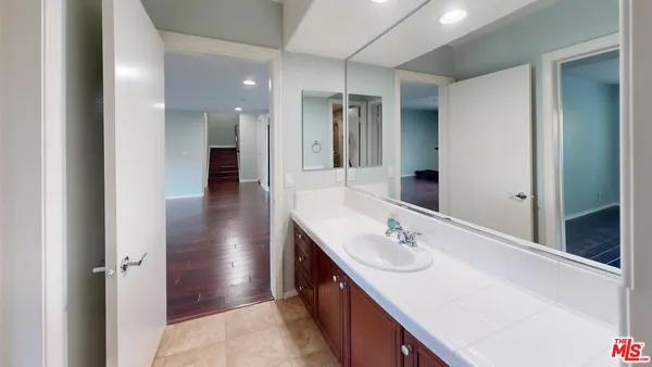 a bathroom with a sink double vanity and a mirror