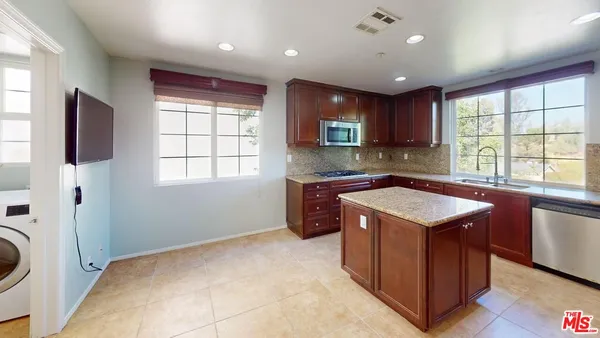 a kitchen with a stove a sink and a refrigerator
