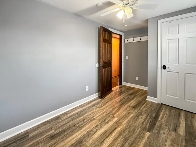 a view of a bedroom with furniture and window