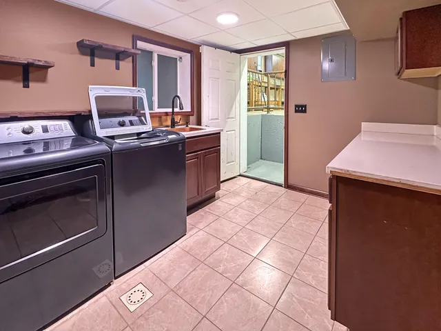 a kitchen with stainless steel appliances a sink stove and cabinets
