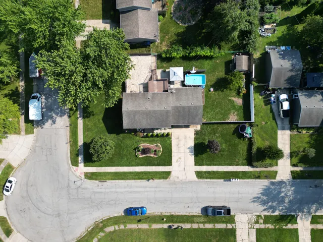 a view of a pool with table and chairs in the patio