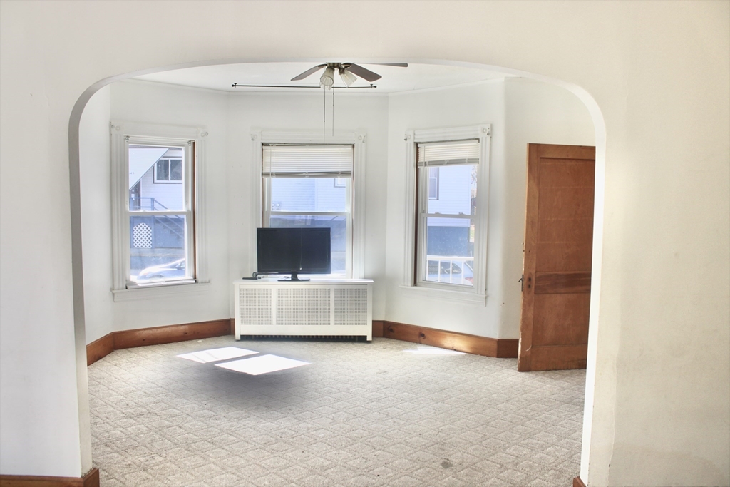136 Horton Street, Unit 1 Fall River, MA 02723 - Photo 7 of 17 a living room with a couch and a window