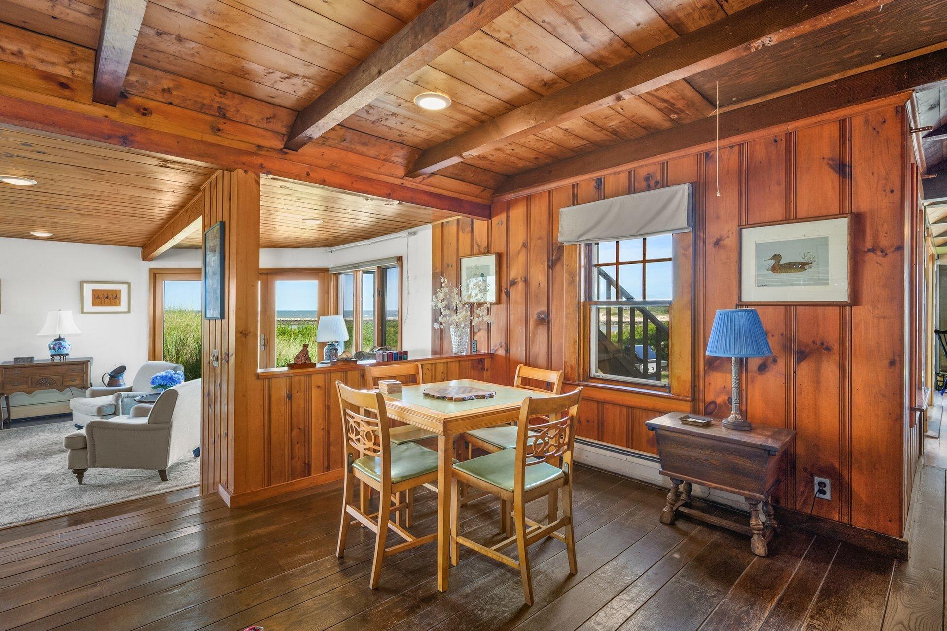40 Harbor Road East Dennis, MA 02641 - Photo 18 of 32 a dining room with wooden floor and large windows