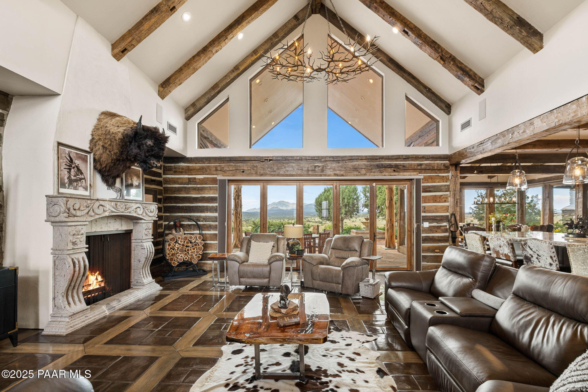 14800 North Puntenney Road Prescott, AZ 86305 - Photo 12 of 100 a living room with furniture a fireplace and a floor to ceiling window