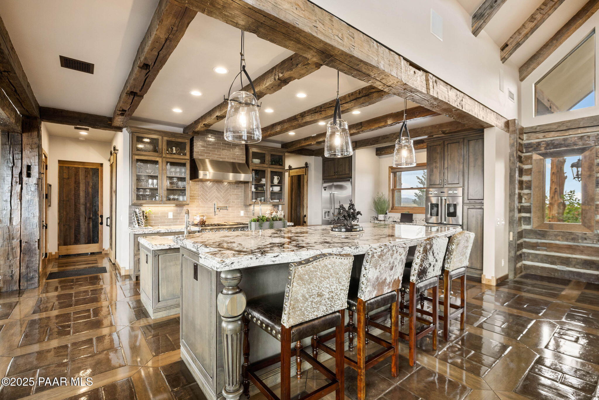 14800 North Puntenney Road Prescott, AZ 86305 - Photo 15 of 100 a kitchen with stainless steel appliances kitchen island granite countertop a table chairs in it and wooden floors