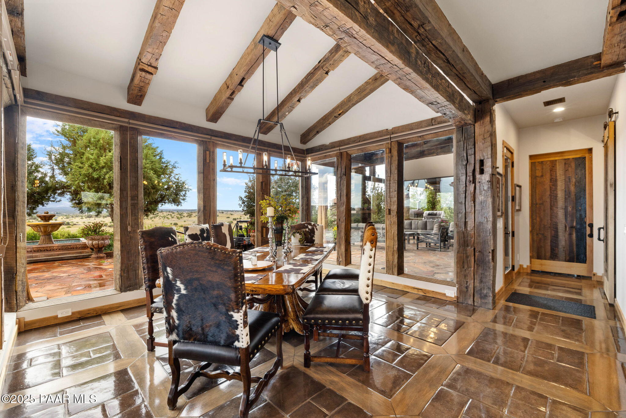 14800 North Puntenney Road Prescott, AZ 86305 - Photo 23 of 100 a view of a dining room with furniture wooden floor and floor to ceiling windows