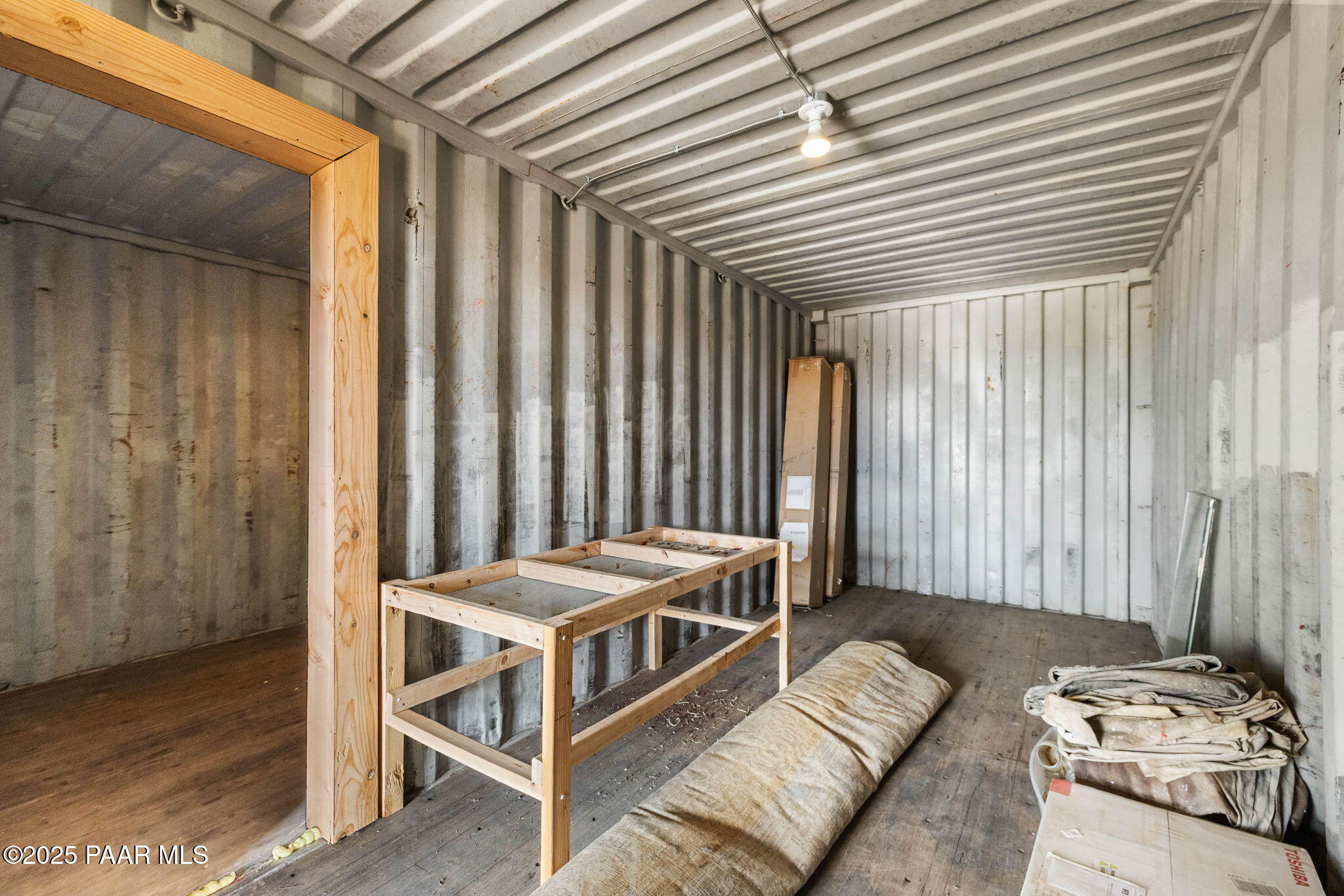 14800 North Puntenney Road Prescott, AZ 86305 - Photo 85 of 100 a bedroom with furniture and a wooden floor