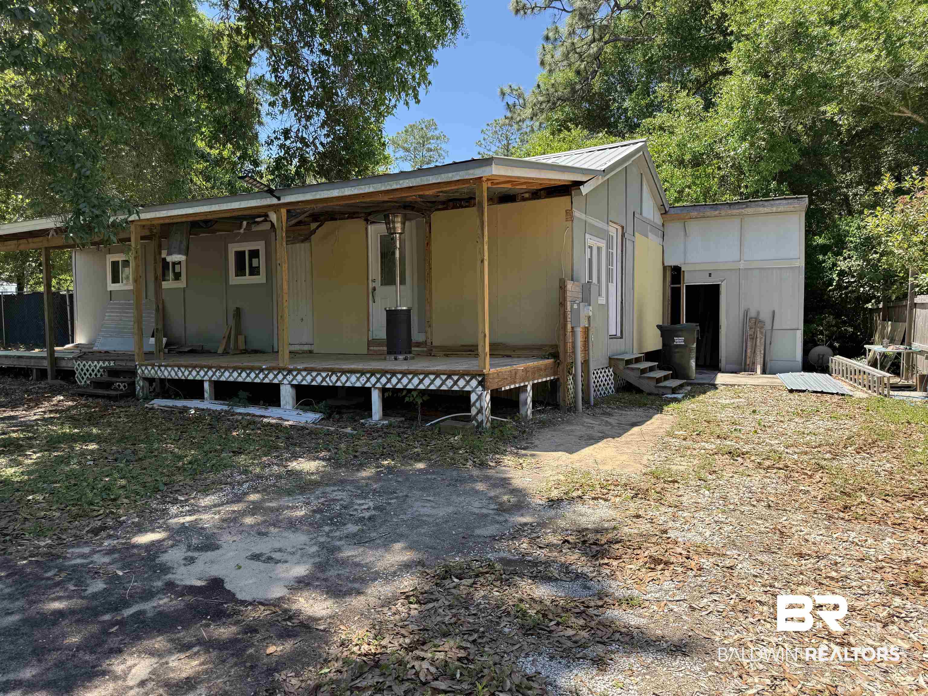 1276 Rio Circle Lillian, AL 36549 - Photo 1 of 7 Expansive covered porch with wood-finish decking and lattice skirting
