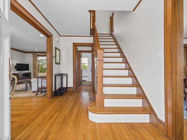 a view of entryway and hall with wooden floor