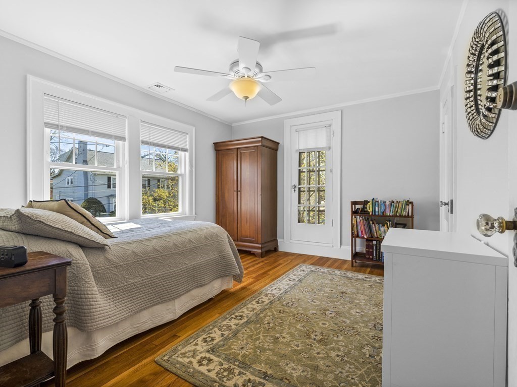 21 Normandy Road Newton, MA 02466 - Photo 14 of 36 a bedroom with a bed and a chandelier