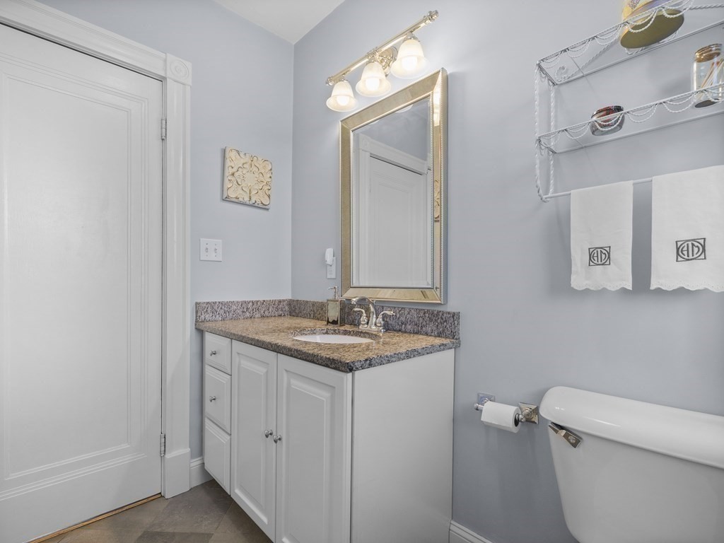 21 Normandy Road Newton, MA 02466 - Photo 26 of 36 a bathroom with a granite countertop toilet sink and mirror