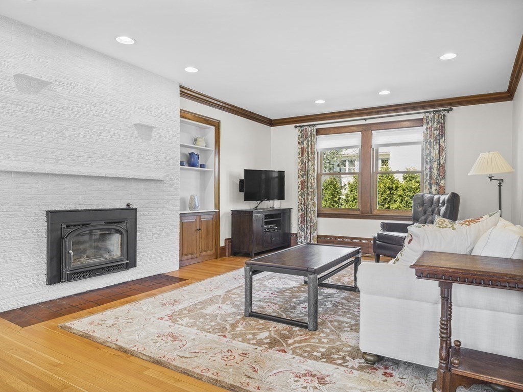 21 Normandy Road Newton, MA 02466 - Photo 3 of 36 a living room with furniture a flat screen tv and a fireplace
