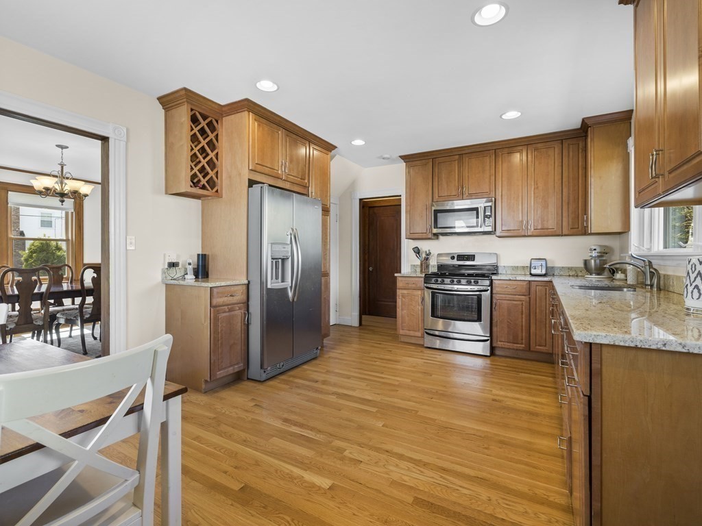 21 Normandy Road Newton, MA 02466 - Photo 9 of 36 a kitchen with stainless steel appliances granite countertop a refrigerator a stove top oven a sink dishwasher and white cabinets with wooden floor