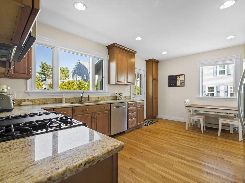 21 Normandy Road Newton, MA 02466 - Photo 10 of 36 a kitchen with stainless steel appliances granite countertop a stove a sink dishwasher and a refrigerator with wooden floor