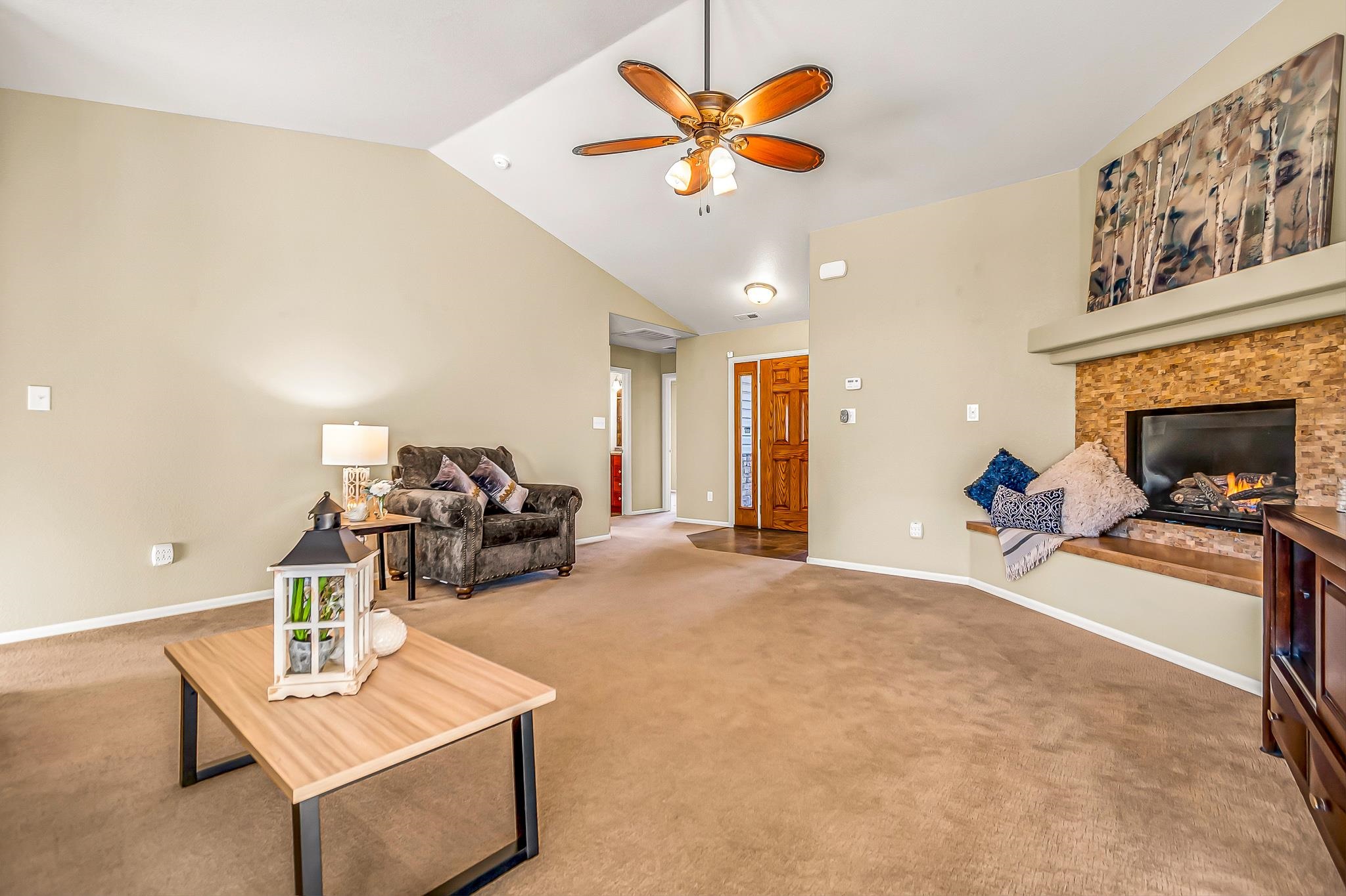 120 Red Rocks Street Fruita, CO 81521 - Photo 6 of 28 a view of a livingroom with a fireplace and a chandelier