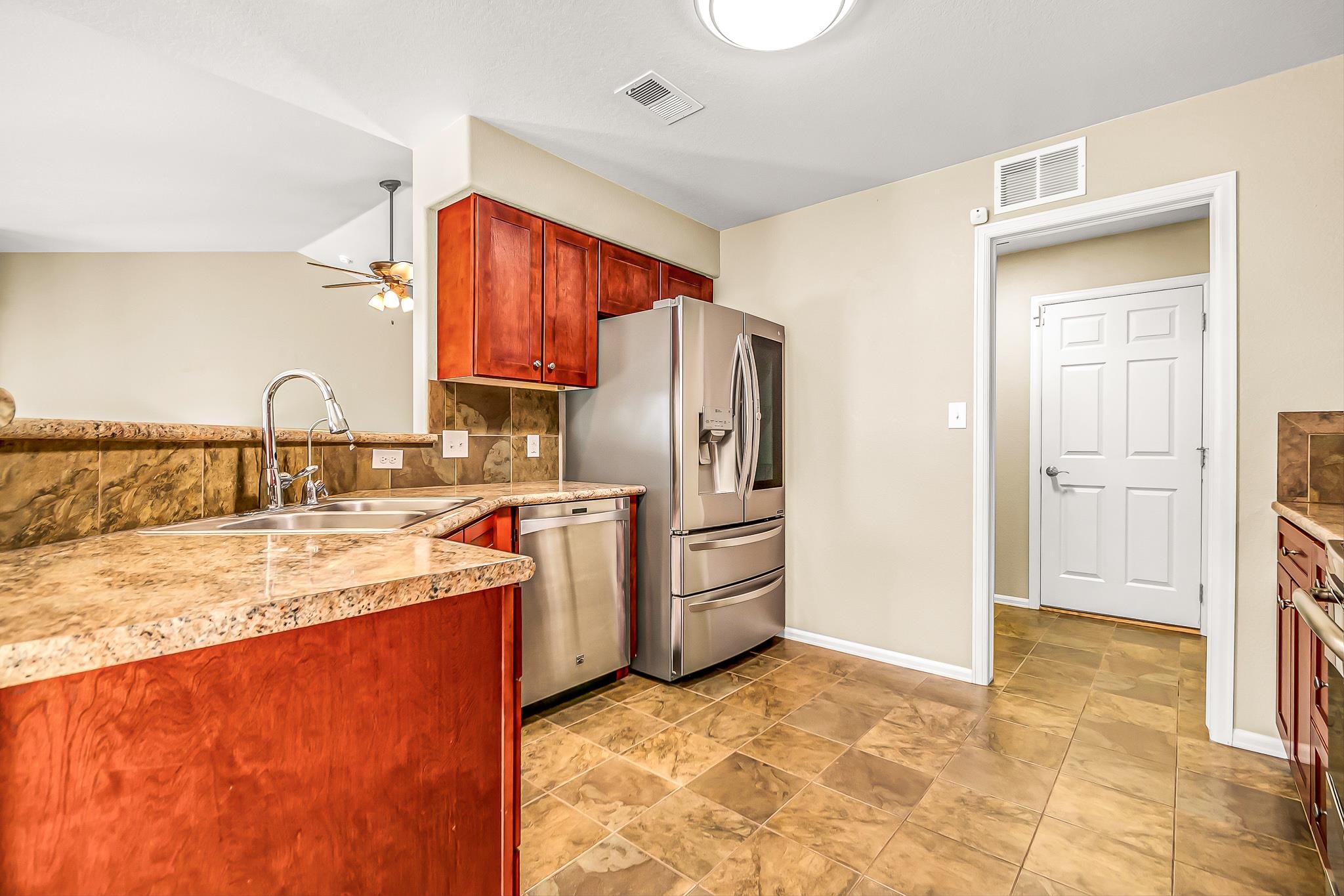 120 Red Rocks Street Fruita, CO 81521 - Photo 10 of 28 a kitchen with stainless steel appliances granite countertop a refrigerator and a stove top oven