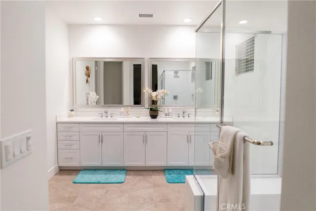 a bathroom with a sink vanity and mirror