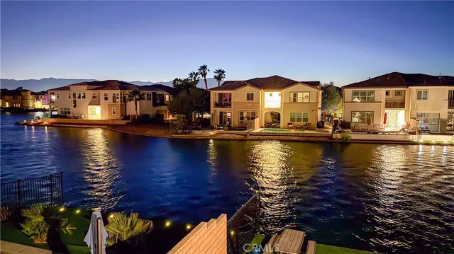 a kitchen with stainless steel appliances a sink a stove a refrigerator a counter top space and cabinets
