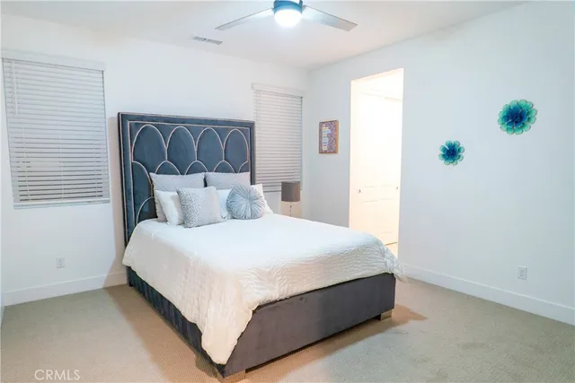 a bedroom with a bed and a mirror