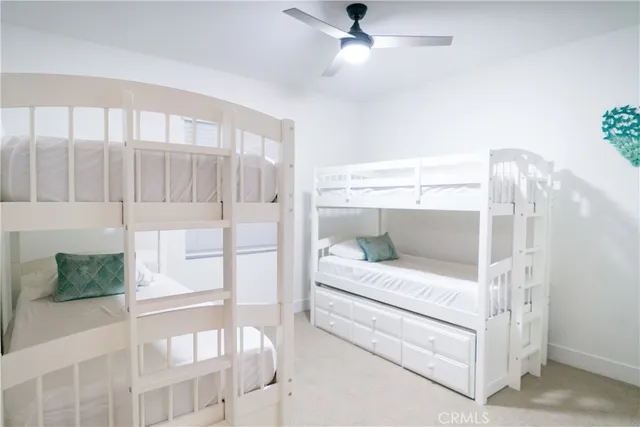 a living room with a couch and a ceiling fan