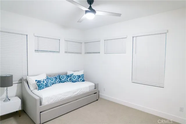 a view of a lake with a yard and potted plants