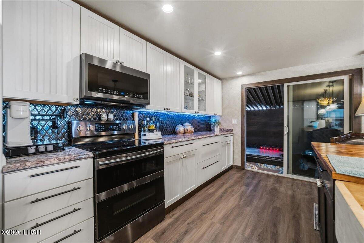 3170 Parker Dam Road, Unit 18 Parker, AZ 85344 - Photo 12 of 88 a kitchen with stainless steel appliances kitchen island granite countertop a stove and a wooden floors