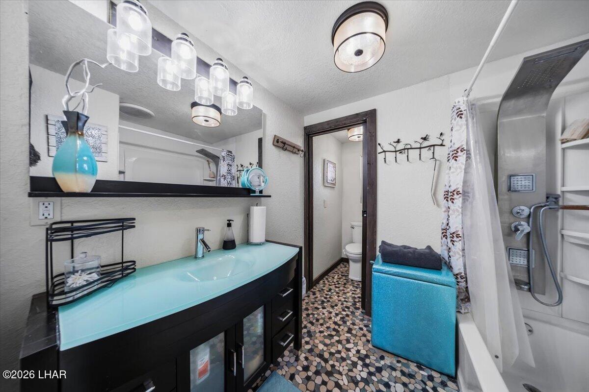 3170 Parker Dam Road, Unit 18 Parker, AZ 85344 - Photo 26 of 88 a bathroom with a sink a mirror and a shower