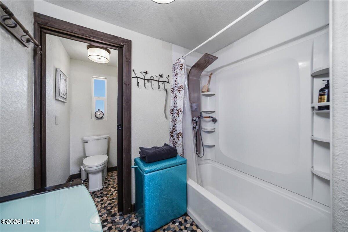 3170 Parker Dam Road, Unit 18 Parker, AZ 85344 - Photo 29 of 88 a bathroom with a tub a toilet and a shower
