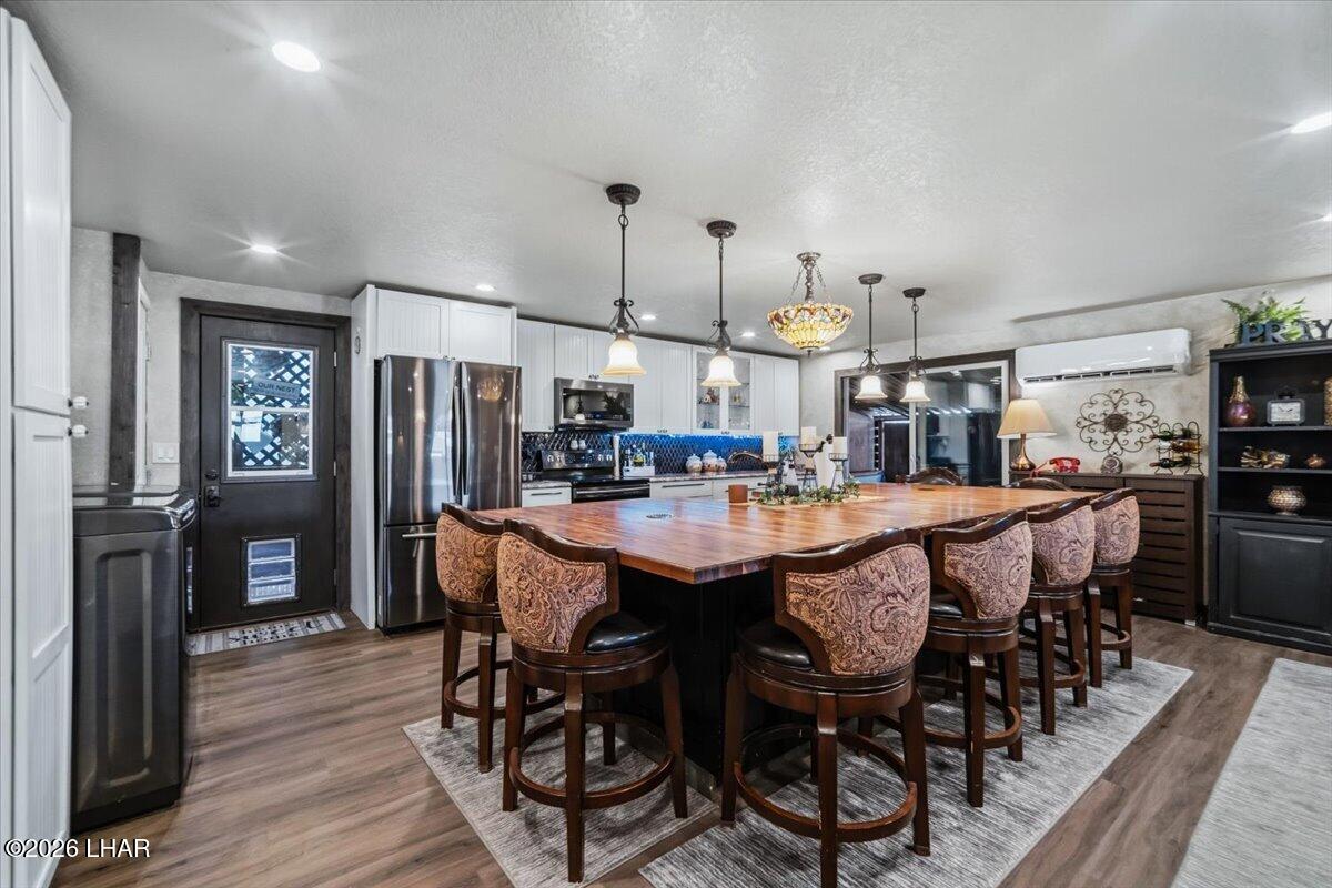 3170 Parker Dam Road, Unit 18 Parker, AZ 85344 - Photo 6 of 88 a dining table with chairs and wooden floor