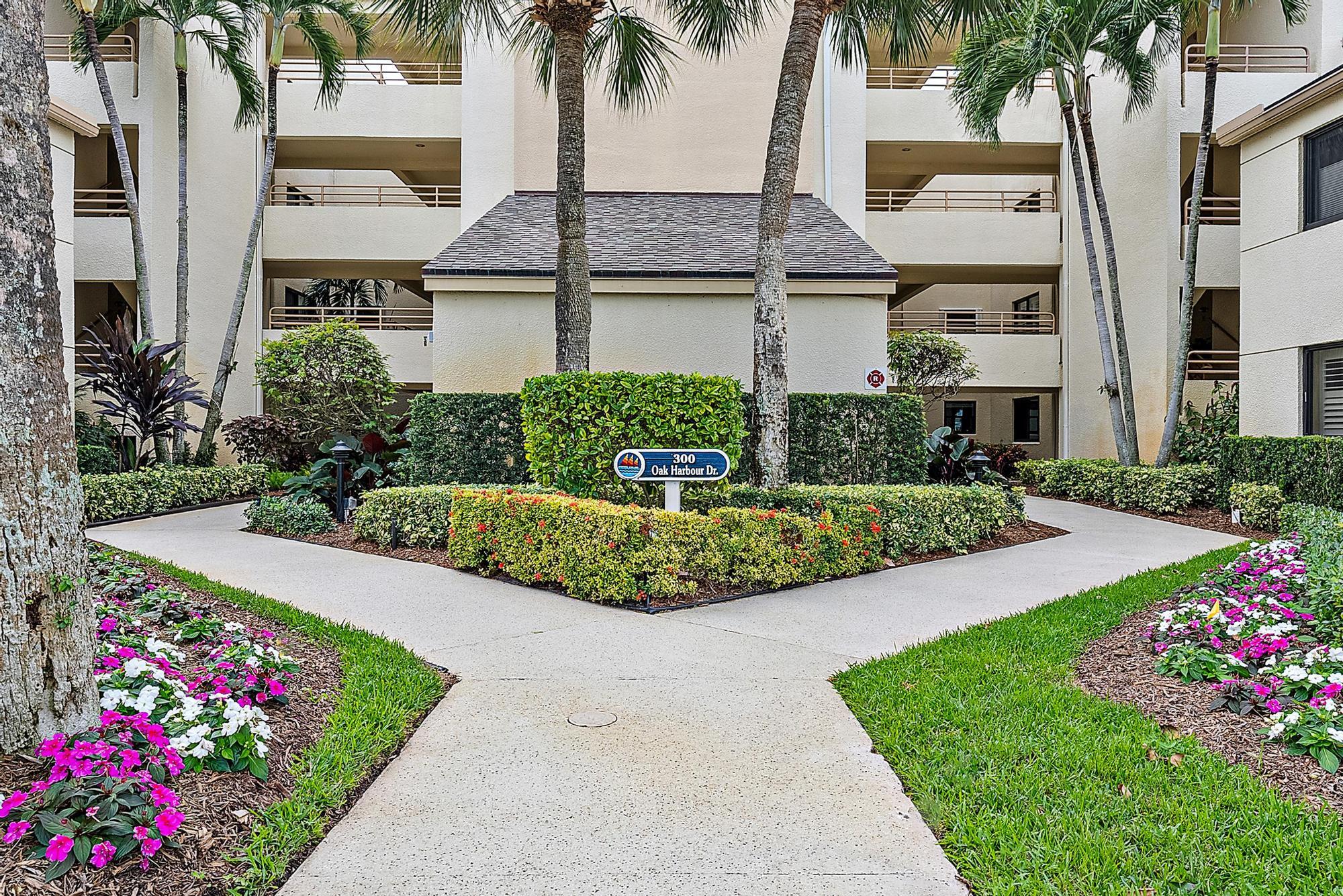 326 Oak Harbour Drive Juno Beach, FL 33408 - Photo 35 of 41 a front view of a house with a garden and trees
