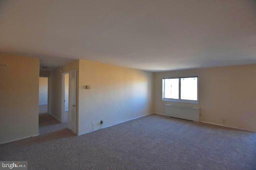 4313 Knox Road, Unit 501 College Park, MD 20740 - Photo 4 of 17 an empty room with a empty space and windows
