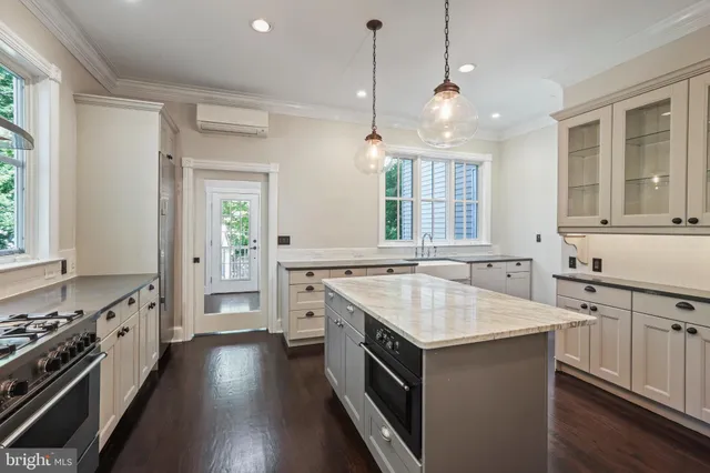 a kitchen with a sink stove and cabinets