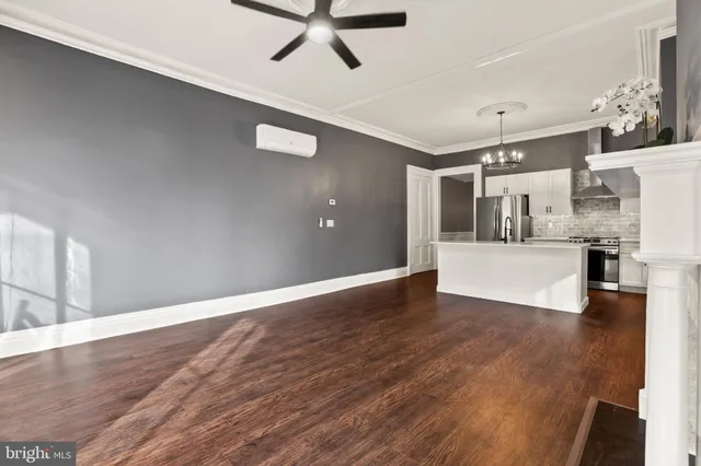 a view of a hallway with wooden floor and entryway