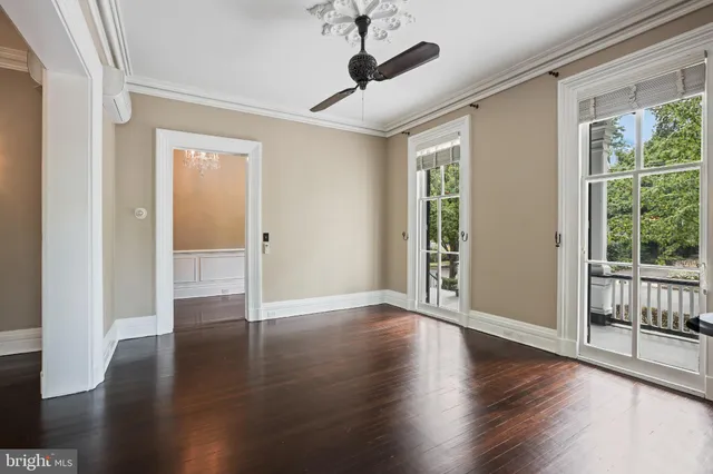 a view of a livingroom with wooden floor fireplace and windows