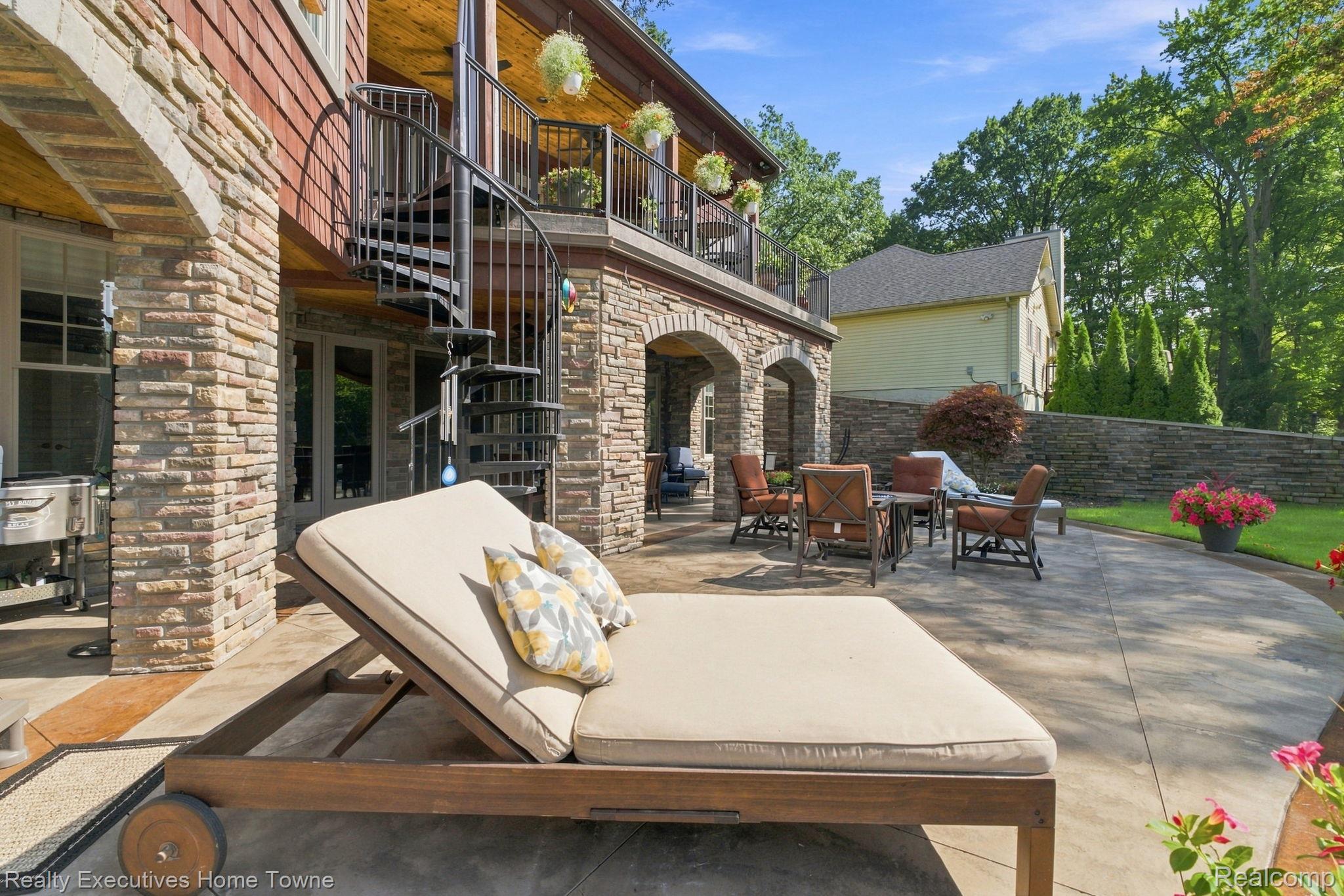 2829 Riverside Drive Port Huron, MI 48060 - Photo 60 of 99 Stone veneer exterior with arched entryways, spiral staircase, and covered patio