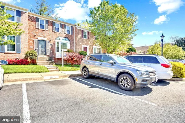 a front view of a house with a garden and garage