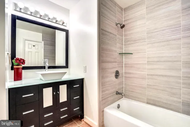 a bathroom with a sink mirror vanity and toilet