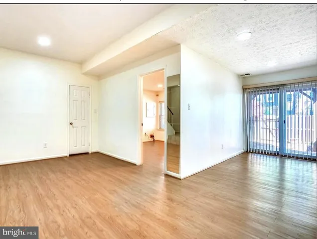 an empty room with wooden floor