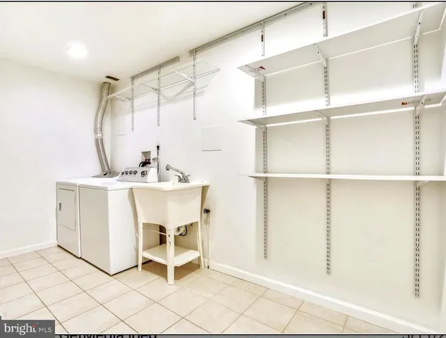 a bathroom with a sink a toilet and a window