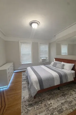 a bathroom with a sink a toilet a mirror and shower curtain