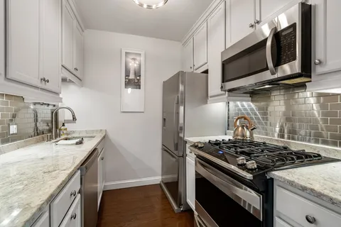 a kitchen that has a sink and a stove