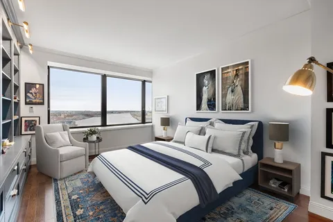 a bedroom with a bed and a large window