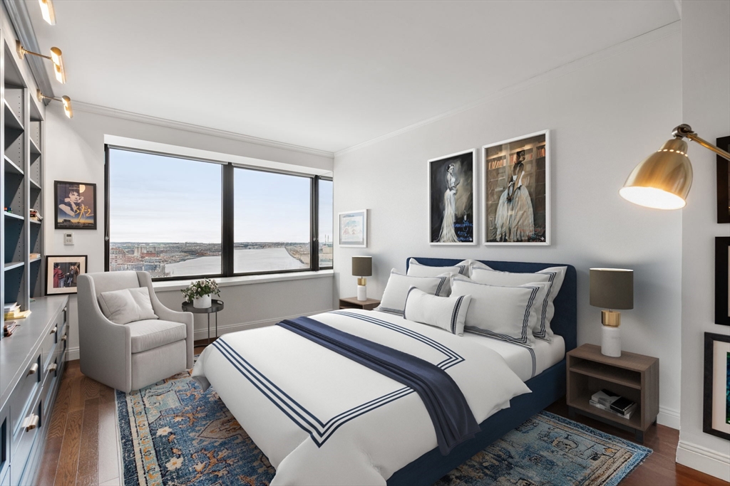 85 East India Row, Unit 19H Boston, MA 02110 - Photo 14 of 23 a bedroom with a bed and a large window