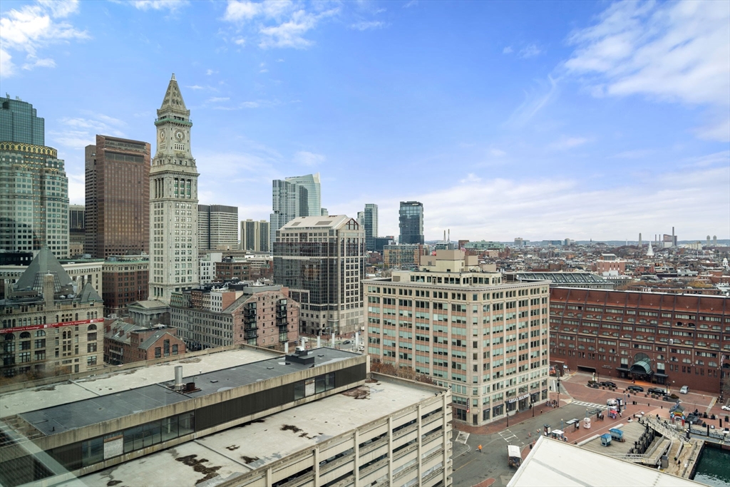 85 East India Row, Unit 19H Boston, MA 02110 - Photo 19 of 23 a view of a city with tall buildings