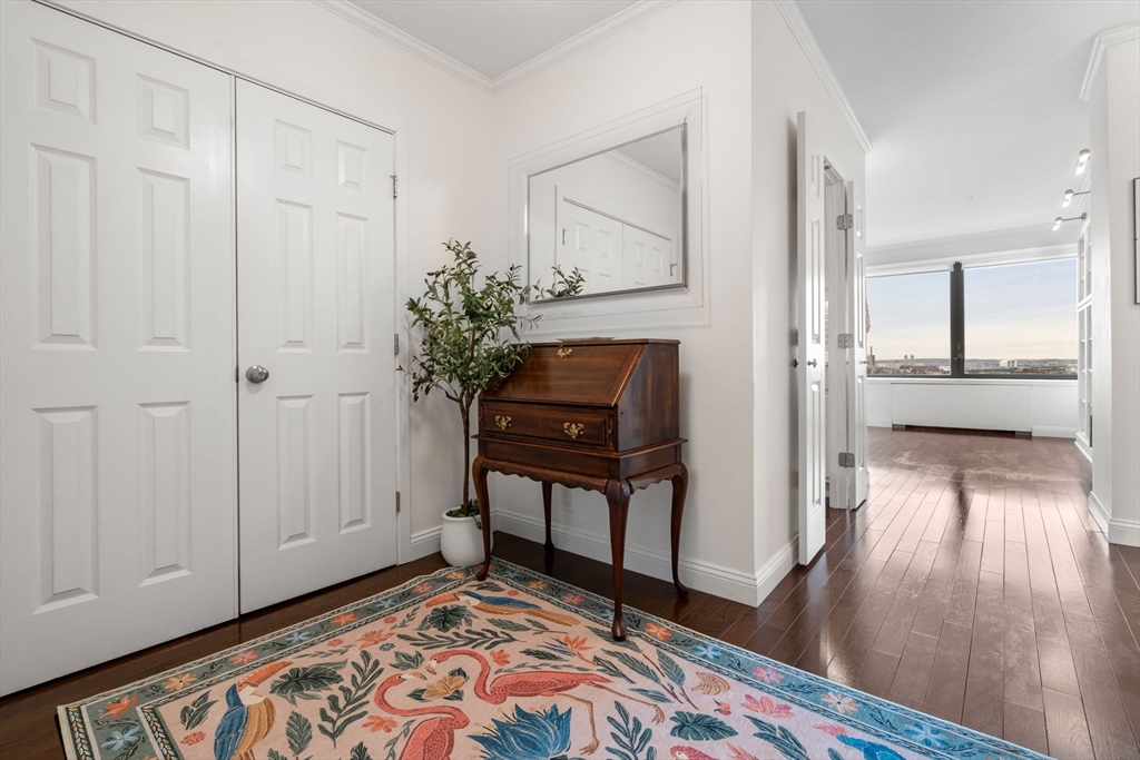 85 East India Row, Unit 19H Boston, MA 02110 - Photo 2 of 23 a view of a room with wooden floor and furniture