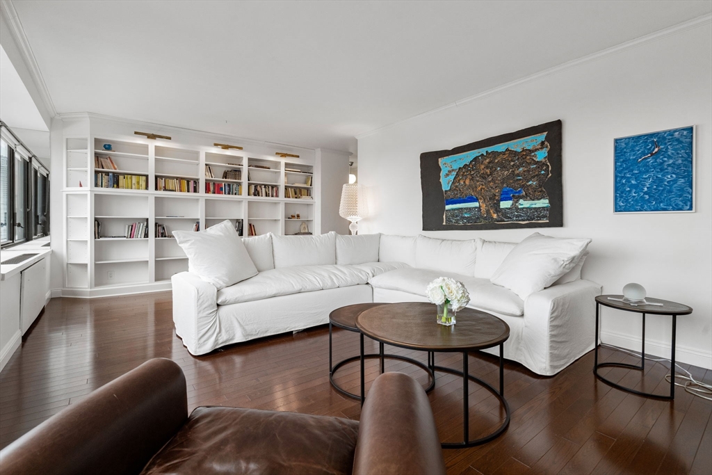 85 East India Row, Unit 19H Boston, MA 02110 - Photo 7 of 23 a living room with furniture and a flat screen tv