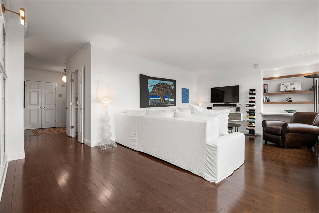 85 East India Row, Unit 19H Boston, MA 02110 - Photo 10 of 23 a living room with furniture and a flat screen tv