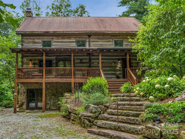 a front view of a house with plants