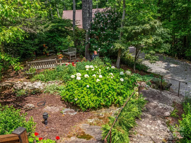 a backyard of a house with a yard and outdoor seating