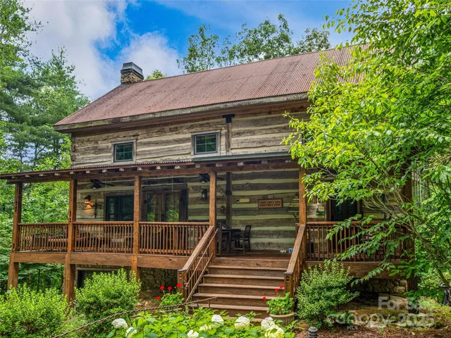 a view of a house with a window and wooden fence